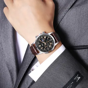 Detail of a men's business watch featuring a black dial and brown leather strap on a suit