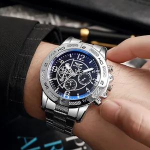 Close-up of a silver stainless steel men's watch with a deep blue dial on a wrist