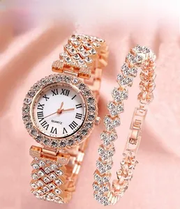 Detail of rose gold quartz watch set with heart bracelet on pink silk background