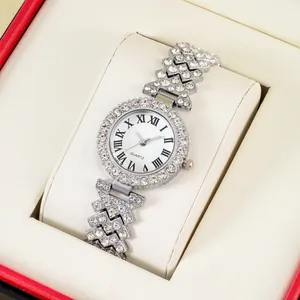 Close-up of diamond-encrusted silver watch with Roman numerals in a luxury gift box