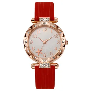 Detail of a ladies' quartz watch with starfish dial, red strap and crystal accents
