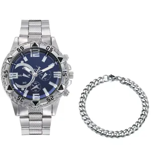 Detailed view of silver steel watch with blue dial and matching Cuban chain bracelet