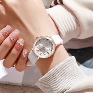 Women's quartz watch with white silicone strap and rose gold case on wrist