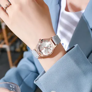 Detail of rose gold diamond-encrusted bezel with flower pattern dial and grey strap