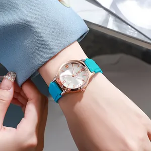 Close-up of women's quartz watch with floral dial, rhinestone bezel and blue silicone strap