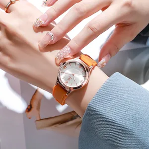Close-up of orange silicone strap watch with rose gold rhinestone bezel and floral dial