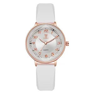 Modern women's quartz watch with white silicone strap and rose gold bezel on white background