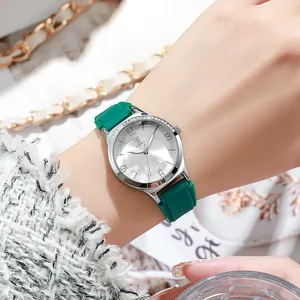 Elegant women's quartz watch with green silicone strap and floral rhinestone dial display