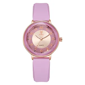 Detail of pink silicone strap and rose gold watch case with faceted diamond-cut glass