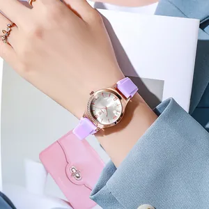 Close-up of stylish women's watch with rose gold case and floral dial on lavender strap