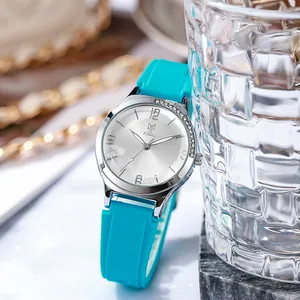 Detail of teal silicone watch strap with floral silver dial and sparkling bezel accent