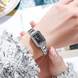 Close-up of elegant square quartz watch with silver steel band on a female wrist