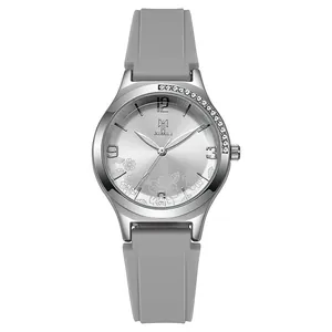 Detail of silver watch dial with floral pattern and grey silicone strap texture