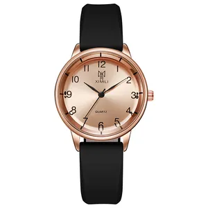 Close-up of rose gold quartz watch with minimalist dial and black silicone strap