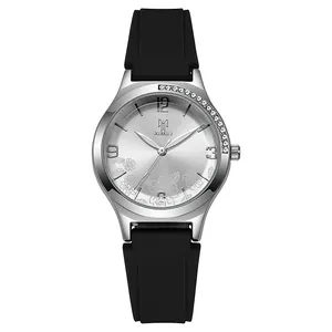 Detailed close-up of silver watch dial with floral pattern and black silicone strap