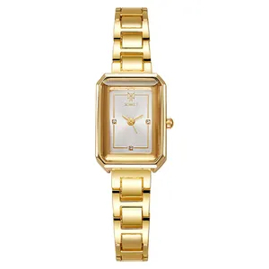 Macro view of rectangular gold watch case with diamond markers and silver dial