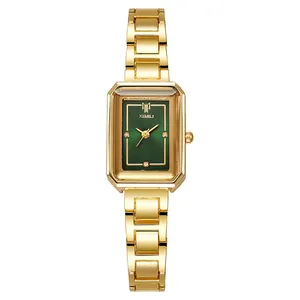 Detail of vintage square gold watch with green dial and gemstone markers