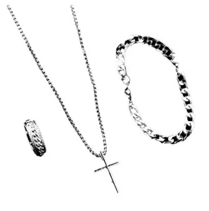 Close-up of men's jewelry set with cross pendant necklace, Cuban chain and wide ring
