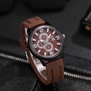 Close-up of brown silicone watch strap and black case showing the date display window