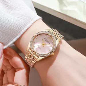 Luxury gold women's quartz watch with rhinestone bezel and pink dial on model's wrist