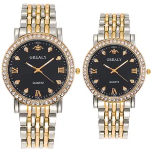 Macro detail of luxury couple quartz watches with gold-tone steel bands and diamond bezels
