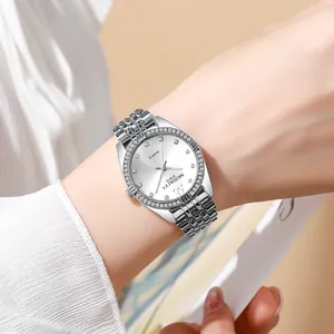 Detailed shot of a silver quartz watch with rhinestone bezel on a woman's wrist