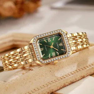 Detail of vintage square gold watch with green sunray dial and sparkling rhinestones