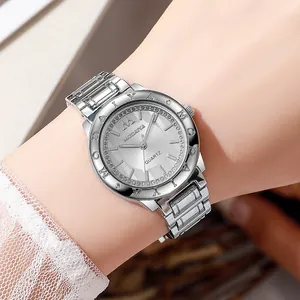 Close-up of a women's silver quartz watch with a sparkling diamond bezel on a wrist