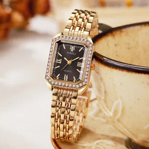 Macro detail of a women's gold rectangular quartz watch with rhinestone bezel on a cup