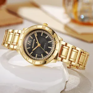 Detailed close-up of a luxury gold quartz watch with a diamond-encrusted black dial on stone