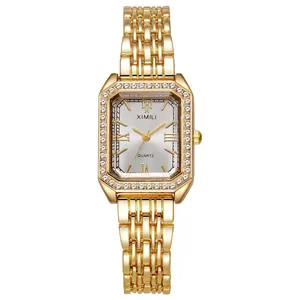 Detailed view of women's square gold watch featuring a diamond-encrusted bezel and silver dial