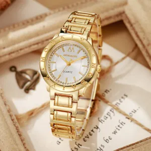 Detailed close-up of a luxury gold quartz watch with a diamond bezel and crystal indices