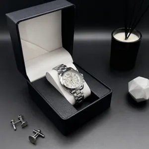 Detail of silver stainless steel men's watch with Roman numerals, cufflinks and gift box