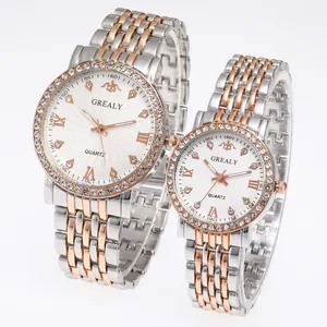 Detail of quartz couple watches with diamond bezels and two-tone steel bands
