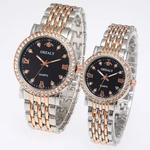 Detail view of GREALY quartz couple watches with diamond bezels and two-tone steel bands
