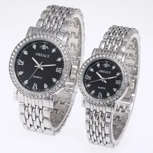 Detail of silver couple watches with black rhinestone dials and metal straps