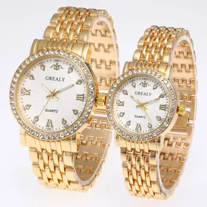 Detail of couple watches with gold metal bands, rhinestone bezels and Roman numerals