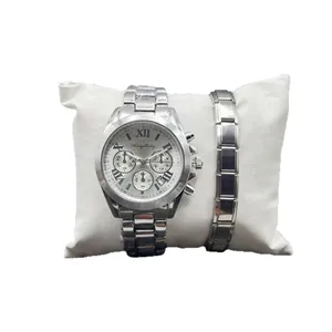 Silver stainless steel watch and bracelet gift set with Roman numerals on a white pillow