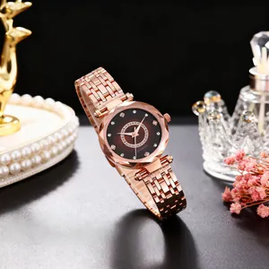 Detail of rose gold watch with sparkling rhinestone dial and faceted glass crystal cover