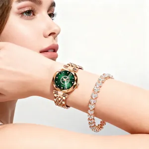 Detail of rose gold quartz watch with green star dial and heart-shaped diamond bracelet