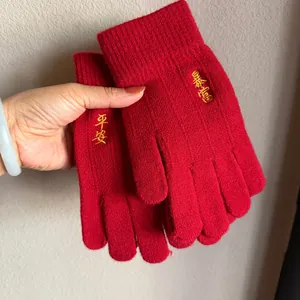 Festive red knit gloves with gold lucky character embroidery for winter warmth