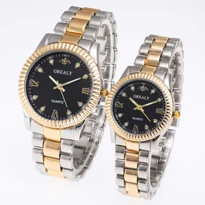 Close-up of luxury couple quartz watches with silver gold steel bands and black dials