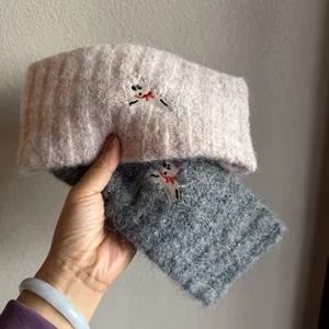 Knitted wool headband with dog embroidery and bow for winter warmth in pink and grey