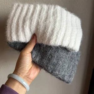 Detail of thick knit headband featuring fuzzy grey and white mohair texture