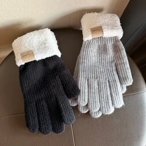 Thick knitted outdoor gloves in black and grey with warm fluffy white fleece cuffs
