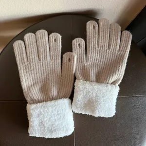 Detail of knitted fingerless gloves with soft white faux fur cuffs and finger openings