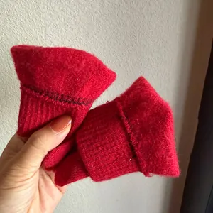Detail of red knit winter gloves with ribbed cuffs and soft warm thermal material