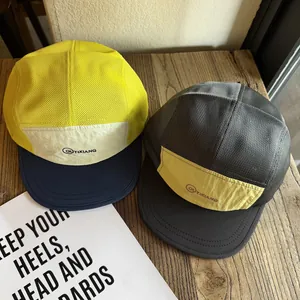 Outdoor color block mesh camp cap with embroidery on a textured wooden surface
