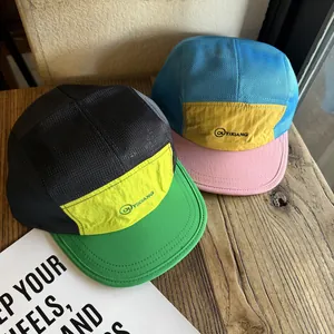 Retro color-block mesh trucker hats with embroidered logo on a premium wooden background