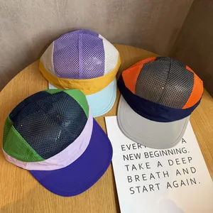 Three colorful mesh panel flat-brim caps in vibrant purple, green, and orange combinations